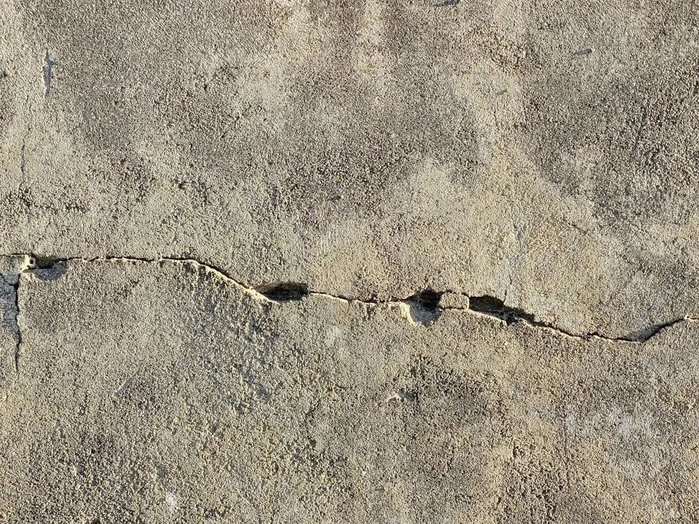 A crack running through a concrete foundation wall