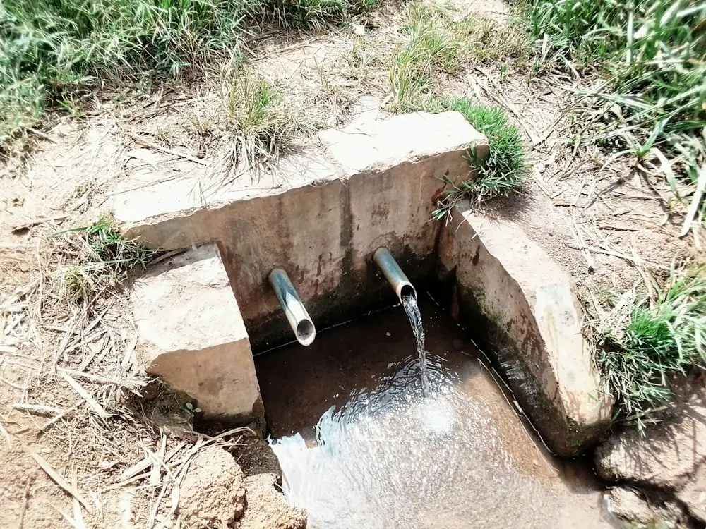 Drain pipes carrying water away into a concrete channel